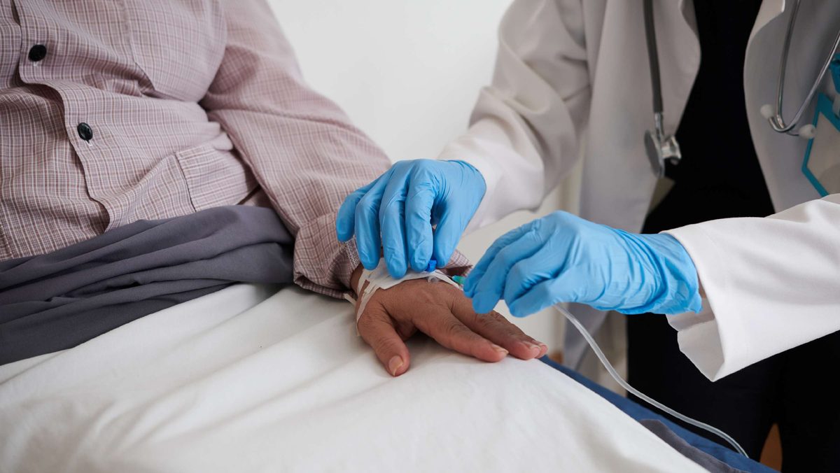 A clinician performing intravenous access for a patient